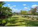 Expansive backyard showcasing a well-kept lawn, vibrant landscaping, and a secure fence, perfect for outdoor enjoyment at 7520 Paradiso Dr, Apollo Beach, FL 33572