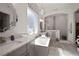 Modern bathroom with a soaking tub, dual vanities, and a separate glass-enclosed shower area at 7520 Paradiso Dr, Apollo Beach, FL 33572