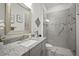 Modern bathroom featuring granite countertop, framed mirror, and glass-enclosed shower at 7520 Paradiso Dr, Apollo Beach, FL 33572