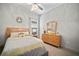 Cozy bedroom with neutral colors, a tray ceiling and well-lit furnishings creating a peaceful atmosphere at 7520 Paradiso Dr, Apollo Beach, FL 33572