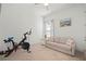 Bright room with exercise bike, comfortable sofa, and a sunlit window at 7520 Paradiso Dr, Apollo Beach, FL 33572