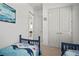 Bright bedroom featuring ocean themed decor, twin beds, and direct hall access at 7520 Paradiso Dr, Apollo Beach, FL 33572