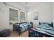 Bedroom with twin beds, colorful ocean themed bedding, and window with blinds at 7520 Paradiso Dr, Apollo Beach, FL 33572