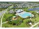 Aerial view featuring a community pool, playground, and lush green spaces for recreation at 7520 Paradiso Dr, Apollo Beach, FL 33572