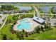 Aerial view of community pool amenities with a lagoon-style pool, cabana, and lush landscaping at 7520 Paradiso Dr, Apollo Beach, FL 33572