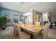 Bright dining room and living room with yellow curtains and tasteful wall color with decor at 7520 Paradiso Dr, Apollo Beach, FL 33572