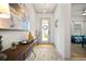 Bright entryway featuring stylish decor, wood-look flooring, and a view into a bedroom at 7520 Paradiso Dr, Apollo Beach, FL 33572