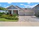 Beautiful single-Gathering home featuring a well-manicured front yard, two-car garage, and charming architectural details at 7520 Paradiso Dr, Apollo Beach, FL 33572