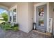 Charming front porch with welcoming decor, comfortable seating, and a beautifully decorated front door at 7520 Paradiso Dr, Apollo Beach, FL 33572