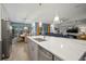 Modern kitchen with a large island, stainless steel appliances, and an open layout to the dining and living areas at 7520 Paradiso Dr, Apollo Beach, FL 33572
