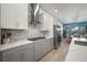 Contemporary kitchen with an island, stainless steel appliances, and an open layout at 7520 Paradiso Dr, Apollo Beach, FL 33572