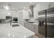 Bright kitchen featuring stainless steel appliances, stylish countertops, and modern cabinetry at 7520 Paradiso Dr, Apollo Beach, FL 33572