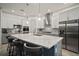 Kitchen with a large island, stainless steel appliances, gray and white cabinets, and modern pendant lighting at 7520 Paradiso Dr, Apollo Beach, FL 33572