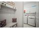 Mudroom featuring a coat rack with storage and a utility area with a washer and dryer at 7520 Paradiso Dr, Apollo Beach, FL 33572
