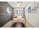 Stylish office with a wood accent wall, modern desk, and neutral decor at 7520 Paradiso Dr, Apollo Beach, FL 33572