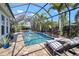Stunning screened-in pool area featuring lounge chairs and a tranquil setting for ultimate relaxation and enjoyment at 7520 Paradiso Dr, Apollo Beach, FL 33572