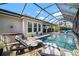 Luxurious screened-in pool area with a spa and lounge chairs, perfect for relaxation and outdoor living at 7520 Paradiso Dr, Apollo Beach, FL 33572