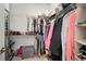 Spacious walk-in closet with multiple shelves and hanging rods for optimal storage and organization at 7520 Paradiso Dr, Apollo Beach, FL 33572
