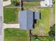 Aerial view of a charming single-Gathering home featuring a well-manicured lawn and a private backyard at 7806 N Matanzas Ave, Tampa, FL 33614