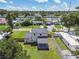 Aerial view of a home in a neighborhood showing its large backyard, covered patio, and neighborhood at 7806 N Matanzas Ave, Tampa, FL 33614