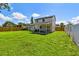 Large backyard featuring a lush green lawn, covered patio, perfect for Gathering gatherings and outdoor enjoyment at 7806 N Matanzas Ave, Tampa, FL 33614