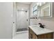 Updated bathroom with a glass door shower, striking black and white tile, and modern vanity at 7806 N Matanzas Ave, Tampa, FL 33614