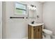 Nicely remodeled bathroom featuring a wood vanity with dark hardware and modern lighting at 7806 N Matanzas Ave, Tampa, FL 33614