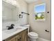 Bright bathroom featuring a modern vanity with black hardware and a well-lit mirror and a window at 7806 N Matanzas Ave, Tampa, FL 33614
