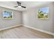 Inviting bedroom with natural light from two windows and light hardwood flooring at 7806 N Matanzas Ave, Tampa, FL 33614