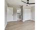 Clean bedroom featuring a ceiling fan, and an adjacent bathroom and closet with white doors at 7806 N Matanzas Ave, Tampa, FL 33614