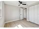 Bedroom featuring a ceiling fan, a window, neutral paint, closet, and light wood-look flooring at 7806 N Matanzas Ave, Tampa, FL 33614