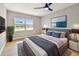 Relaxing bedroom with a large window, ceiling fan, and a comfortable bed with stylish decor at 7806 N Matanzas Ave, Tampa, FL 33614