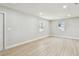 Bright bedroom featuring two windows, light colored laminate flooring, and fresh paint at 7806 N Matanzas Ave, Tampa, FL 33614