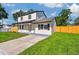 Stylish two-story home with a green lawn, complemented by a well-maintained landscape at 7806 N Matanzas Ave, Tampa, FL 33614