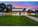 Charming two-story home with a well-maintained lawn and inviting front porch at 7806 N Matanzas Ave, Tampa, FL 33614