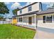 Inviting front porch and well-manicured lawn enhancing the charm of this home at 7806 N Matanzas Ave, Tampa, FL 33614