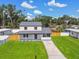 Well-maintained home with a beautiful front yard, a neatly paved driveway and vibrant green grass at 7806 N Matanzas Ave, Tampa, FL 33614