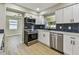 Updated kitchen boasts stainless steel appliances, new cabinets, and a stylish backsplash at 7806 N Matanzas Ave, Tampa, FL 33614