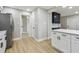 Open-concept kitchen with stainless steel appliances, white cabinets and spacious countertops at 7806 N Matanzas Ave, Tampa, FL 33614