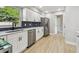 Well-equipped kitchen with stainless steel appliances, ample cabinet space, and modern finishes at 7806 N Matanzas Ave, Tampa, FL 33614