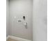 A vacant laundry area with hookups, neutral paint, and wood-look flooring at 7806 N Matanzas Ave, Tampa, FL 33614