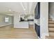 Light-filled living room open to kitchen with stylish cabinets and modern finishes at 7806 N Matanzas Ave, Tampa, FL 33614