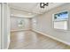 Bright living room with hardwood floors, recessed lighting, and natural light from multiple windows at 7806 N Matanzas Ave, Tampa, FL 33614