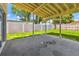 Covered patio featuring a large backyard with a white vinyl fence at 7806 N Matanzas Ave, Tampa, FL 33614