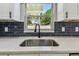 Close up of a modern sink featuring stainless steel faucet and white quartz countertop at 7806 N Matanzas Ave, Tampa, FL 33614