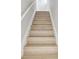Bright and clean staircase featuring light wood treads, white risers, and a fresh white handrail at 7806 N Matanzas Ave, Tampa, FL 33614