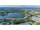 Panoramic aerial view of a neighborhood with homes and a tranquil lake in a sprawling city at 8251 118Th Ave # 8251, Largo, FL 33773