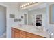 Bathroom featuring dual sinks, wooden cabinetry, and a large mirror at 8251 118Th Ave # 8251, Largo, FL 33773