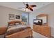 Bedroom featuring wooden furniture, TV, and natural light at 8251 118Th Ave # 8251, Largo, FL 33773