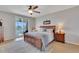 Well-lit bedroom featuring an ensuite bathroom, soft carpet, and access to a screened-in patio at 8251 118Th Ave # 8251, Largo, FL 33773